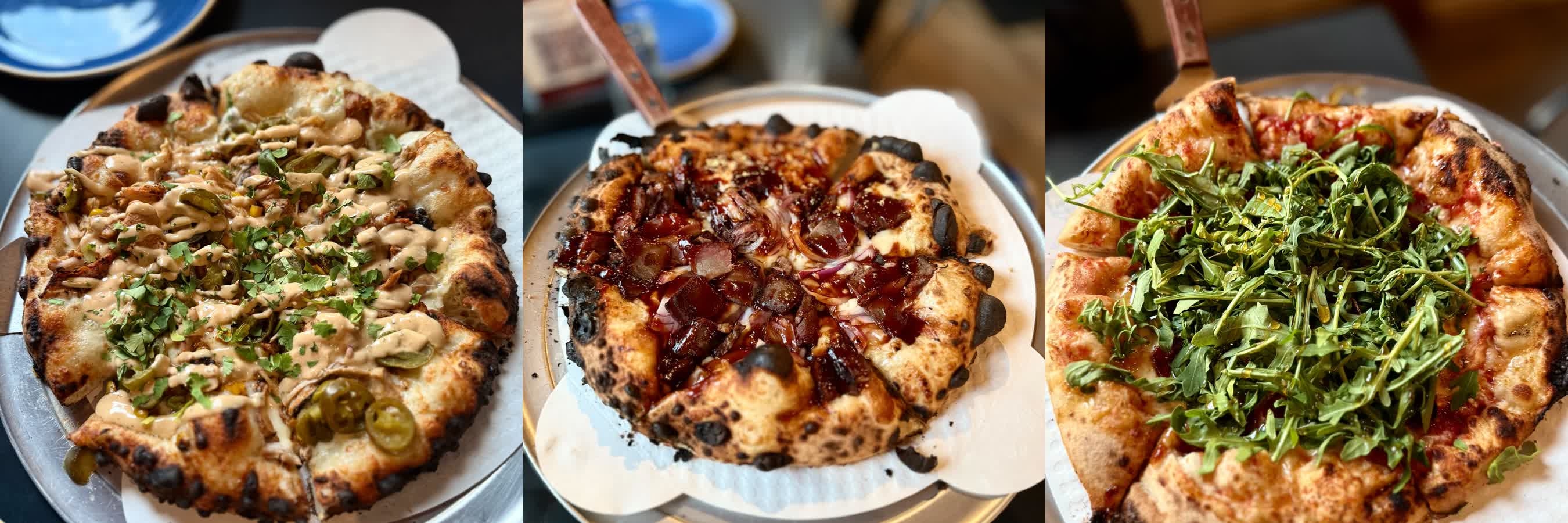 Cluster of three Timber specialty pizzas including Trailblazer, South Peak, and Pemi-Roni