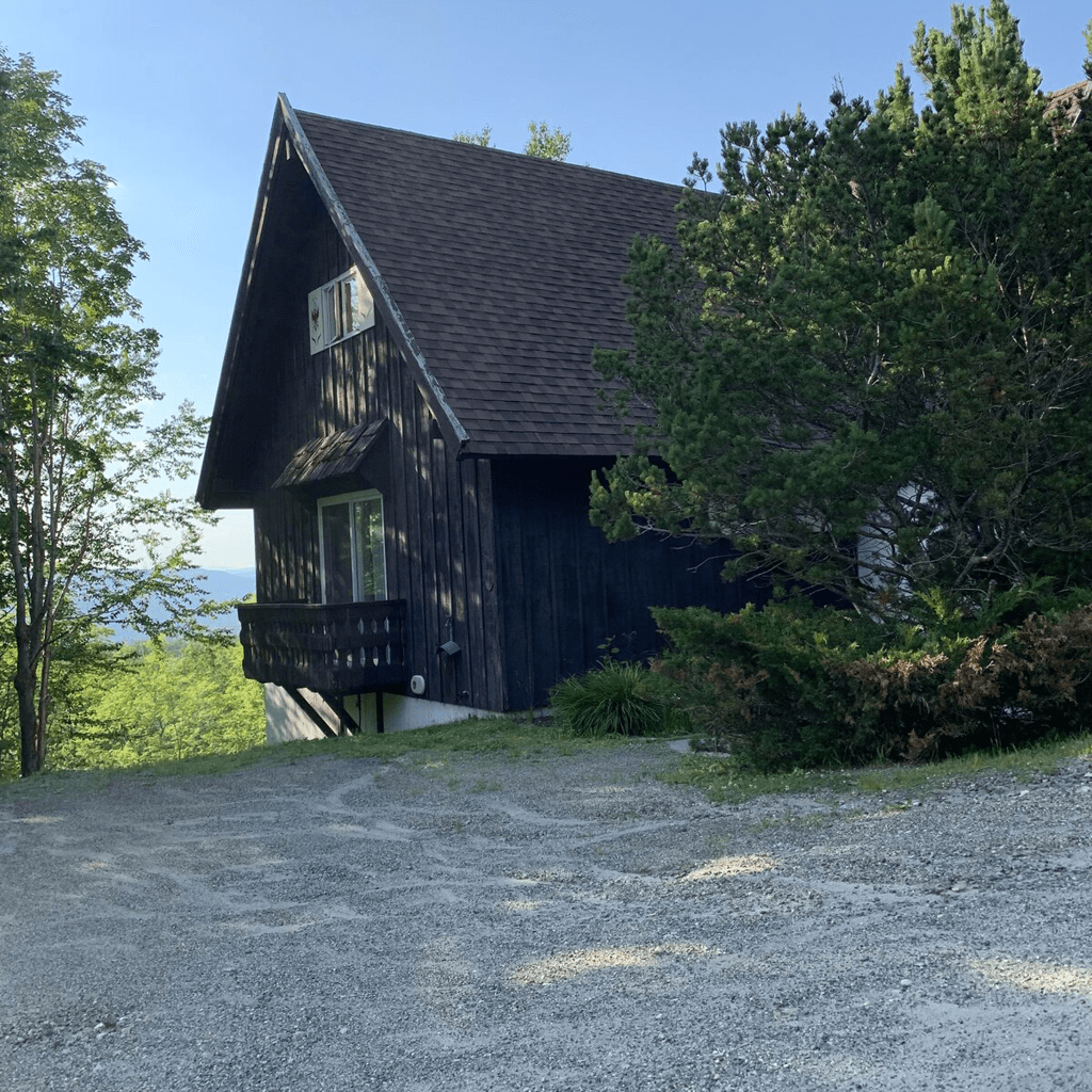 A-frame vacation cabin surrounded by fall foliage in the White Mountains